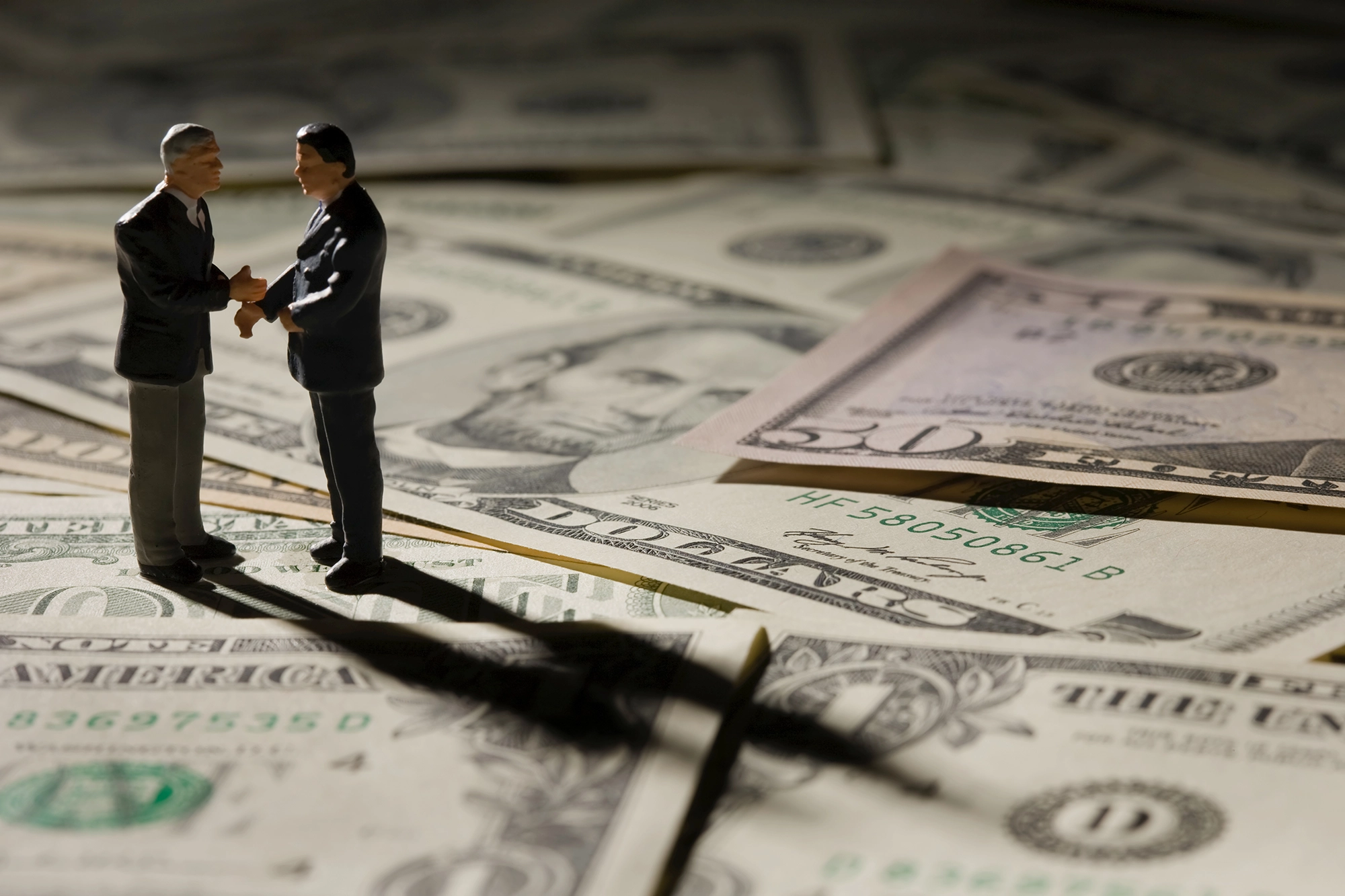 Businessmen on money representing white collar crime