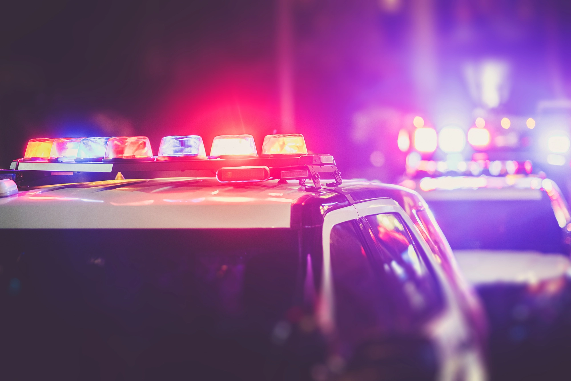 Police car with its lights on at a traffic stop depicting DUI arrest
